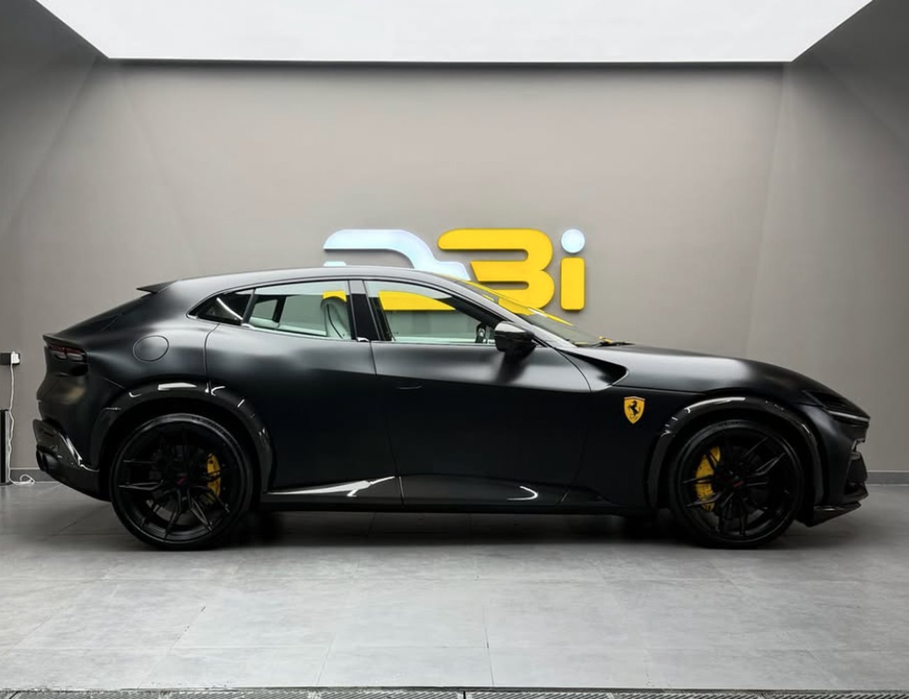 Matte black Ferrari Purosangue in the DBI Motor Wrapping showroom